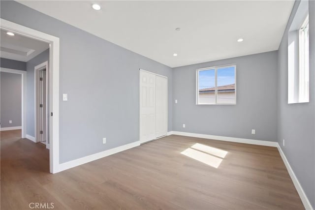 unfurnished room featuring recessed lighting, baseboards, and wood finished floors