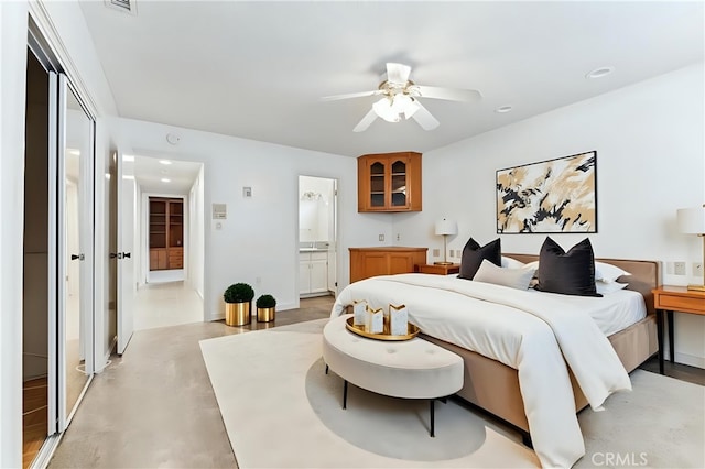 bedroom with visible vents, ensuite bath, finished concrete flooring, recessed lighting, and ceiling fan