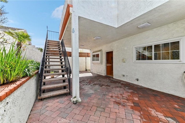 view of patio / terrace with stairway and fence