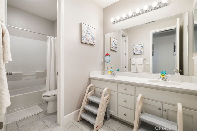 3460 Rogue River Dr, Chico, CA 95973 - full bathroom featuring tile patterned flooring, double vanity, toilet, shower / bath combo, and baseboards