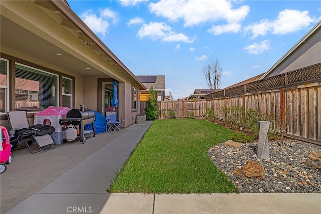 view of yard featuring a patio and a fenced backyard