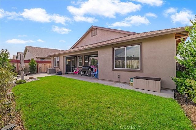 back of house with stucco siding, fence, central AC, and a patio area