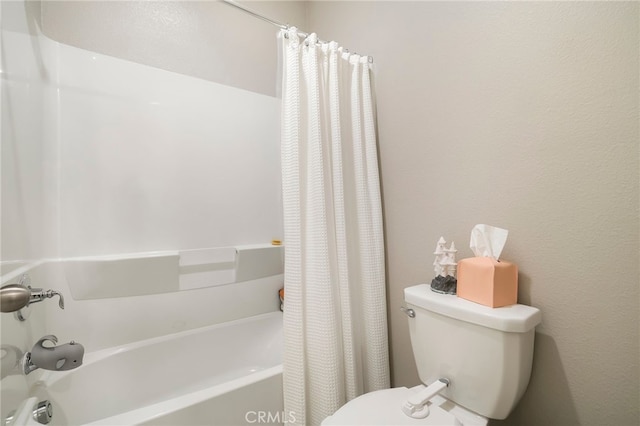 bathroom with shower / bathtub combination with curtain and toilet