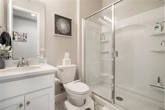 bathroom with vanity, a shower stall, toilet, and tile patterned flooring