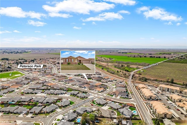 birds eye view of property with a residential view