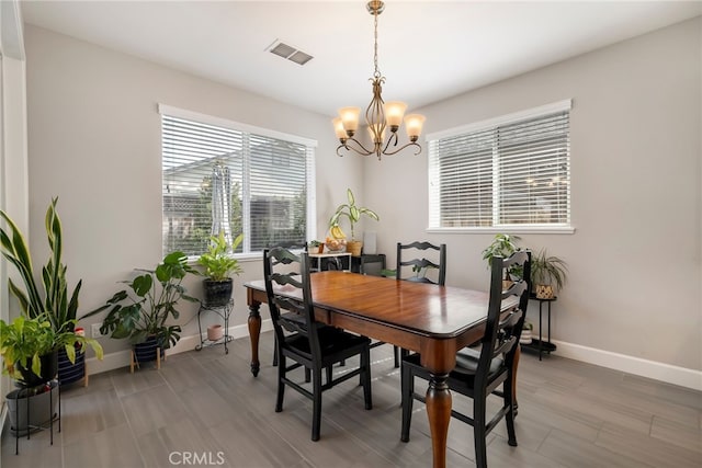 3460 Rogue River Dr, Chico, CA 95973 - dining room featuring a chandelier, baseboards, and light wood finished floors