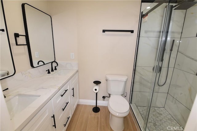 14730 Clark St, Baldwin Park, CA 91706 - bathroom featuring toilet, a shower stall, double vanity, baseboards, and wood finished floors