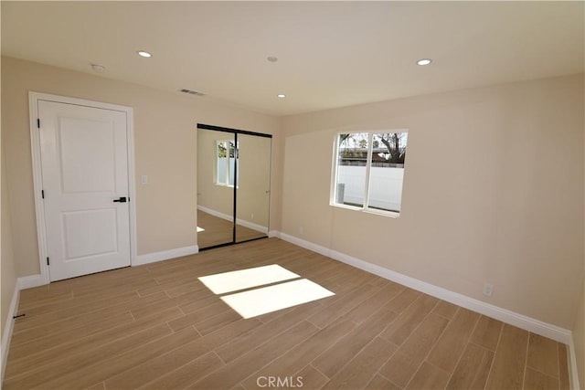 14730 Clark St, Baldwin Park, CA 91706 - unfurnished bedroom with multiple windows, light wood-style floors, baseboards, and recessed lighting