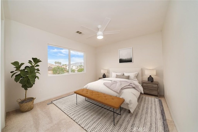 carpeted bedroom featuring a ceiling fan and visible vents