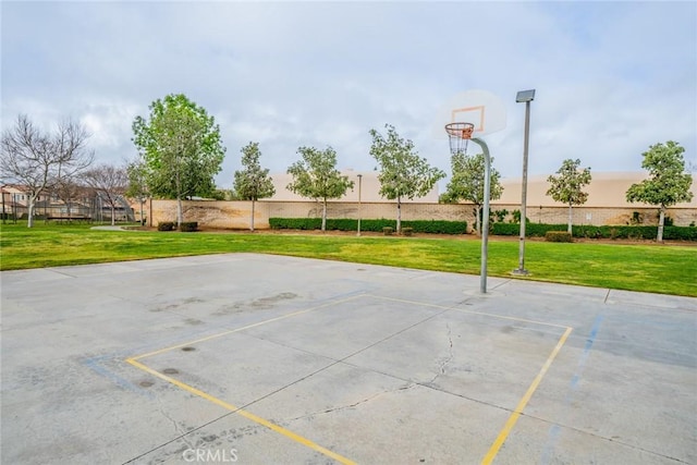 view of basketball court featuring community basketball court and a lawn