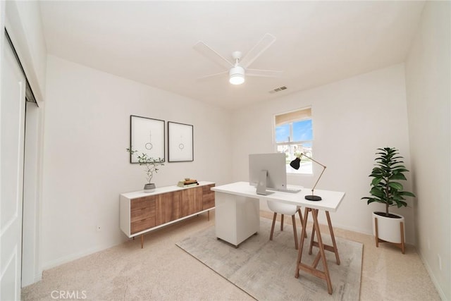 home office with light carpet, baseboards, visible vents, and ceiling fan