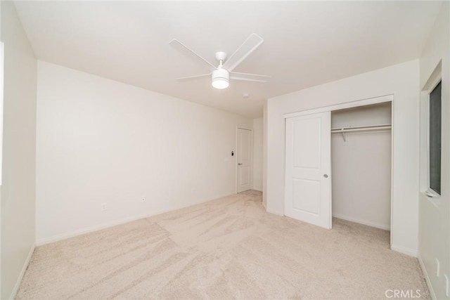 unfurnished bedroom with a closet, baseboards, ceiling fan, and carpet floors