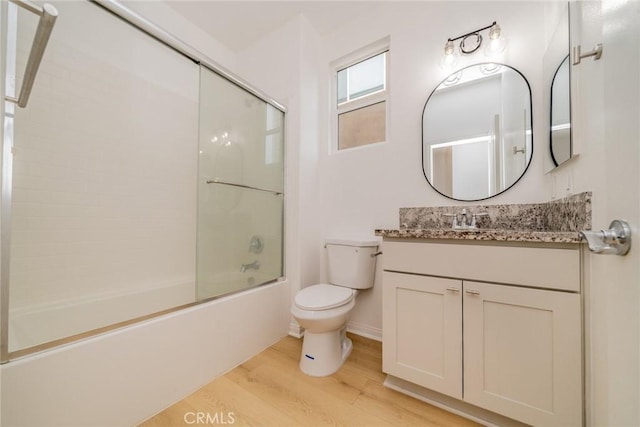 full bathroom featuring enclosed tub / shower combo, toilet, wood finished floors, and vanity