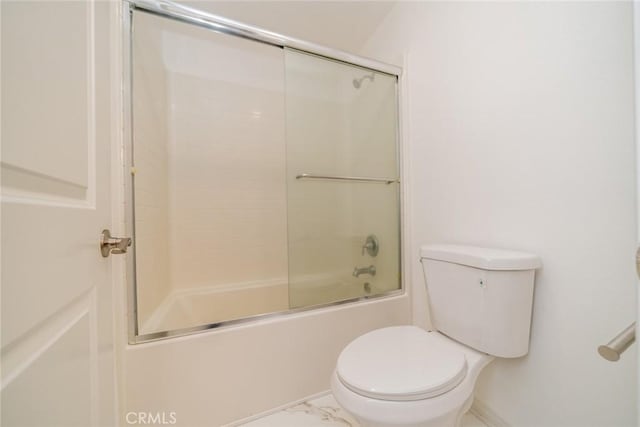 bathroom featuring marble finish floor, toilet, and shower / bath combination with glass door