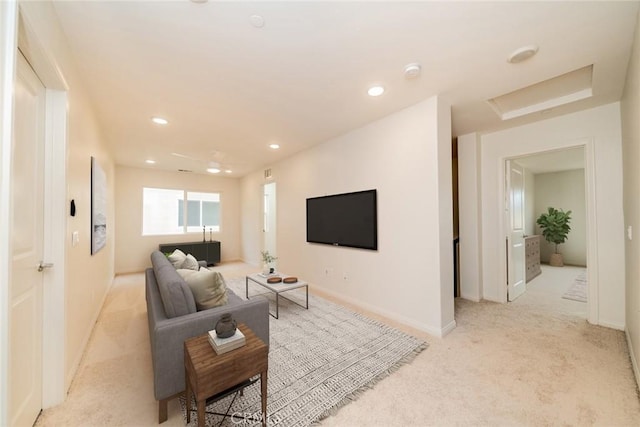 living area with recessed lighting, baseboards, light colored carpet, and attic access