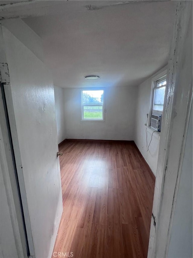 interior space with cooling unit and wood finished floors