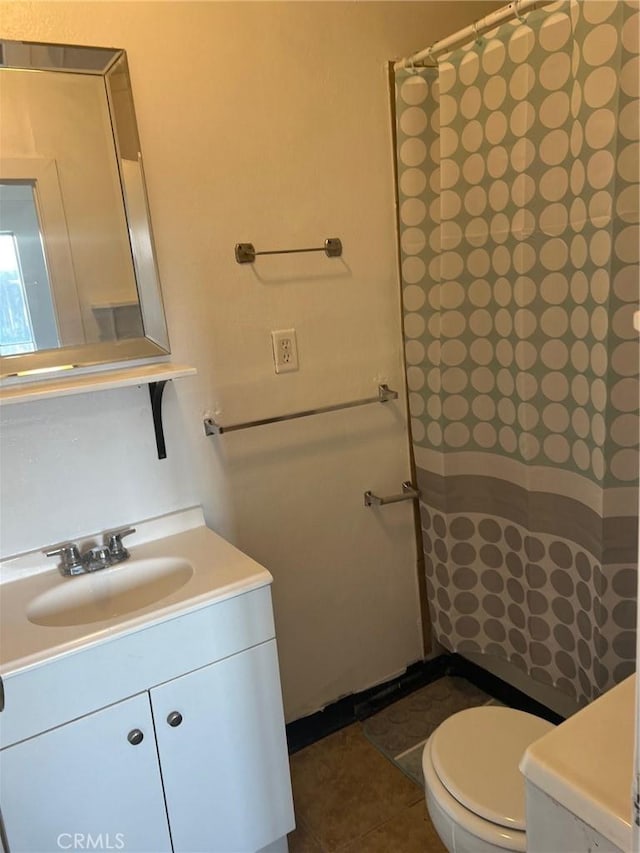 bathroom featuring curtained shower, toilet, vanity, and tile patterned flooring