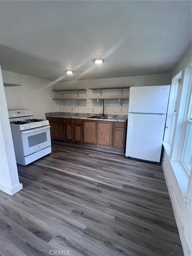 kitchen with white appliances, baseboards, dark wood finished floors, open shelves, and brown cabinets