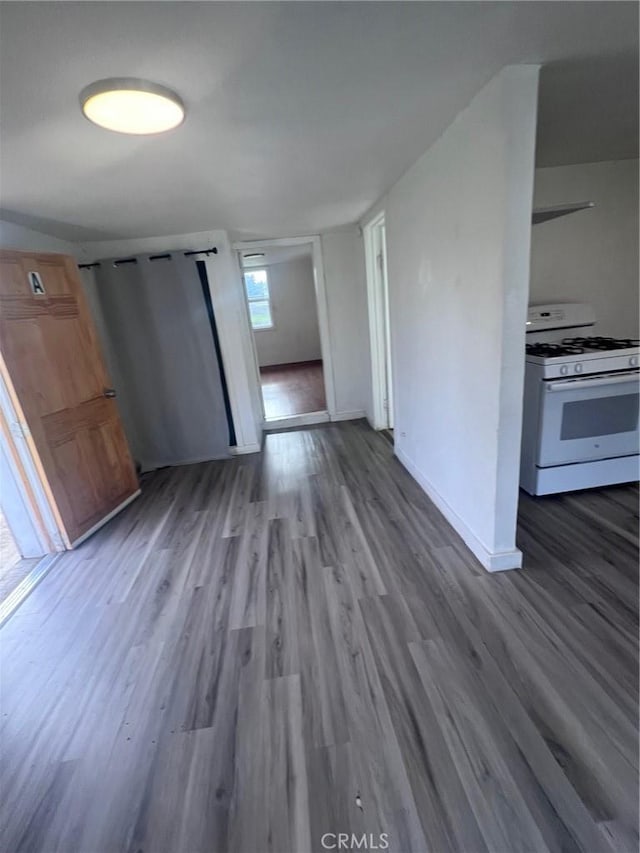 interior space featuring baseboards and wood finished floors