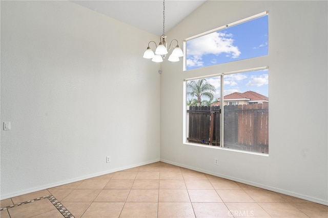 tiled spare room with lofted ceiling, baseboards, and a chandelier