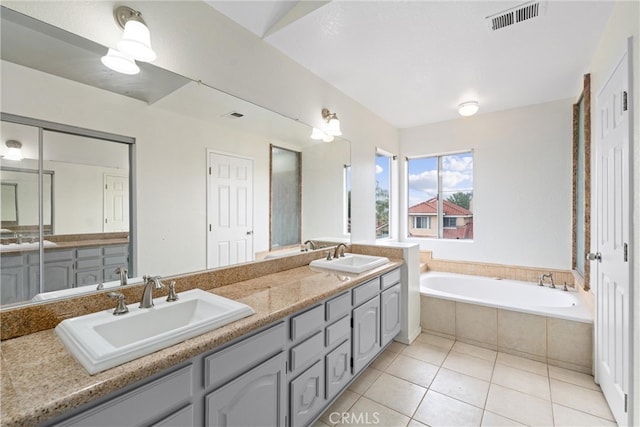 full bath featuring tile patterned flooring, visible vents, a bath, and a sink