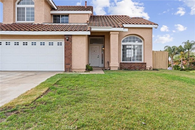 view of front facade with stucco siding, concrete driveway, an attached garage, a front yard, and a tiled roof