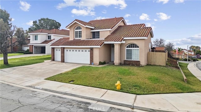 mediterranean / spanish-style house with stucco siding, a front lawn, a tile roof, fence, and concrete driveway