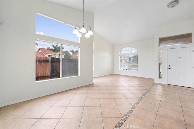 interior space with tile patterned flooring, an inviting chandelier, baseboards, and high vaulted ceiling