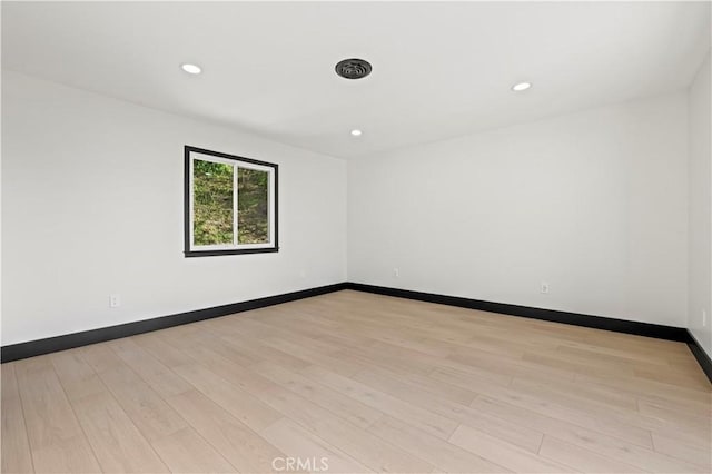 unfurnished room with visible vents, recessed lighting, baseboards, and light wood-type flooring