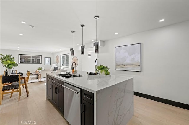 kitchen featuring a sink, light wood-type flooring, stainless steel dishwasher, and recessed lighting