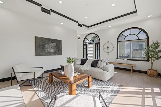 living area with recessed lighting, visible vents, baseboards, and wood finished floors