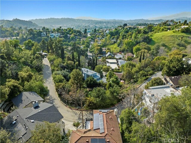 birds eye view of property with a view of trees