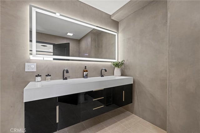 full bathroom featuring double vanity, a sink, and tile patterned flooring