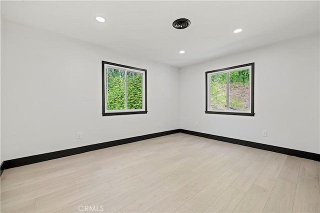 spare room with recessed lighting, visible vents, baseboards, and light wood-style flooring