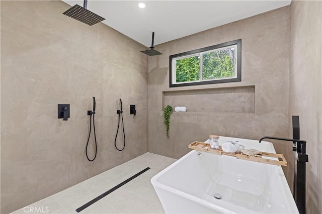 full bathroom with a freestanding bath, tile walls, a tile shower, and a sink