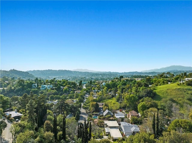 bird's eye view with a forest view and a mountain view