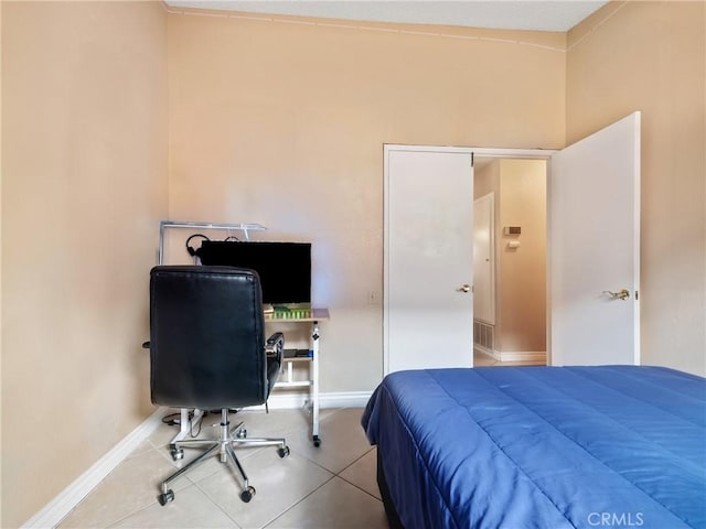 bedroom featuring baseboards and tile patterned flooring