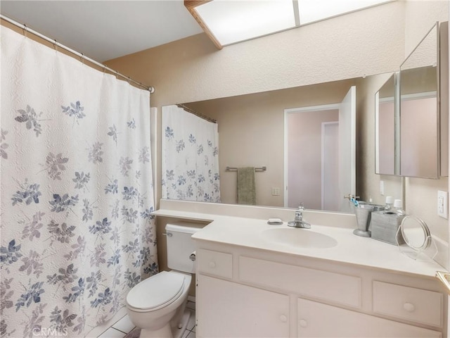 bathroom featuring curtained shower, toilet, and vanity