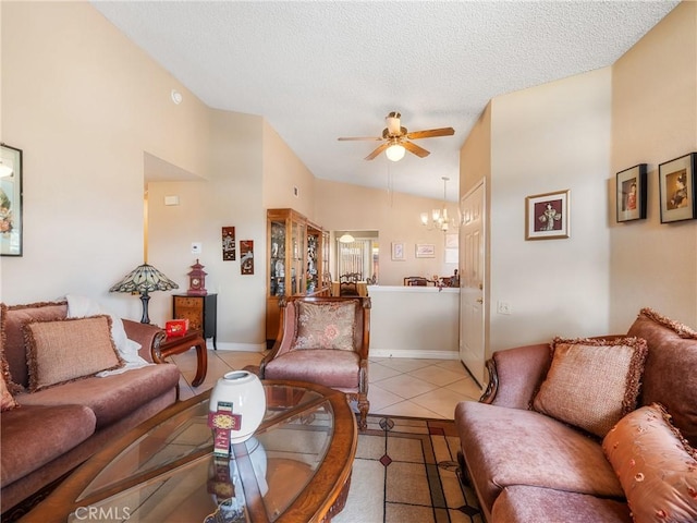 living area with baseboards, ceiling fan, lofted ceiling, light tile patterned flooring, and a textured ceiling