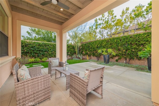 view of patio featuring outdoor lounge area, a fenced backyard, and ceiling fan