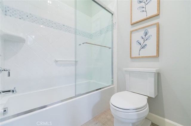 bathroom featuring toilet and enclosed tub / shower combo