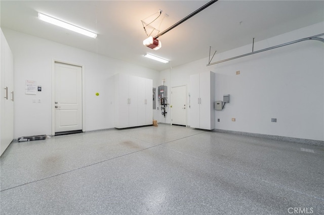 garage featuring a garage door opener and baseboards