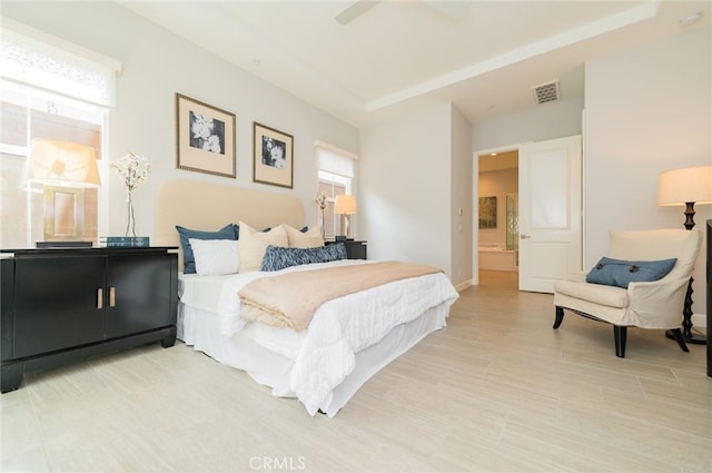 bedroom featuring visible vents, ensuite bathroom, and ceiling fan