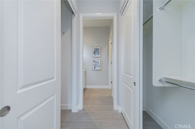 hallway featuring baseboards