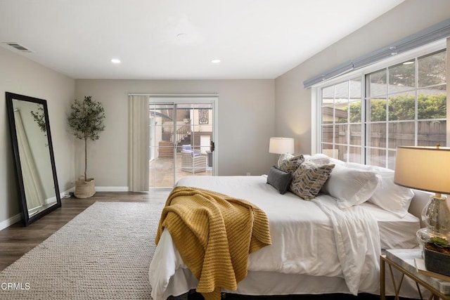 bedroom with recessed lighting, multiple windows, wood finished floors, and baseboards