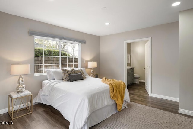 bedroom with recessed lighting, wood finished floors, baseboards, and ensuite bathroom