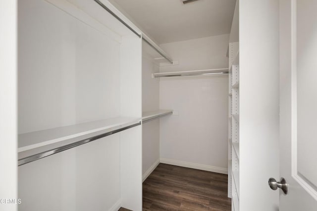 spacious closet featuring dark wood finished floors and visible vents