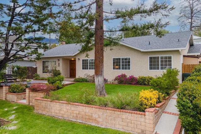 ranch-style house with stucco siding, a shingled roof, and fence