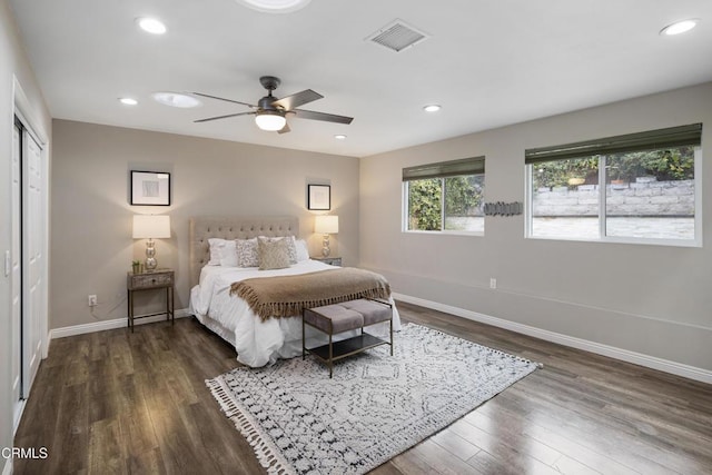 bedroom featuring visible vents, a ceiling fan, dark wood finished floors, recessed lighting, and baseboards