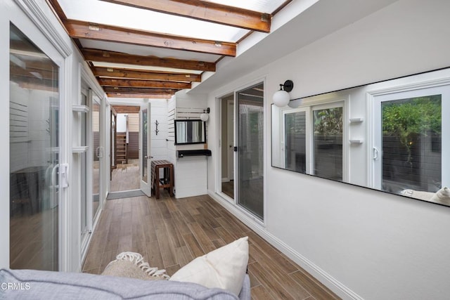 sunroom with beamed ceiling